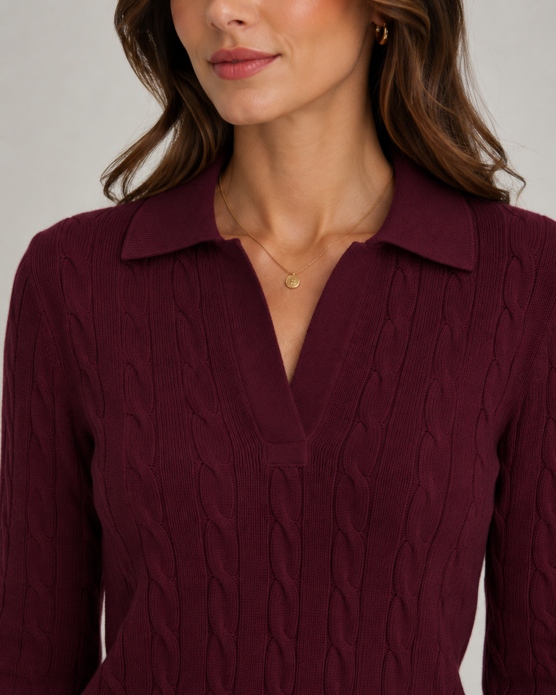 Burgundy cable knit polo sweater with ribbed collar and textured cable pattern