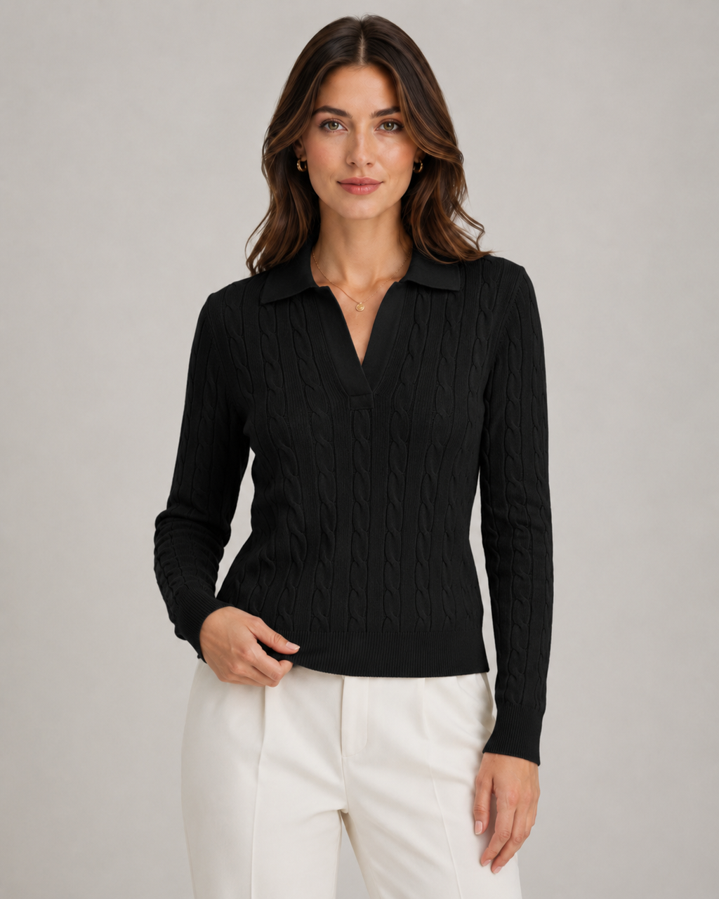 Black cable knit polo sweater with long sleeves, ribbed cuffs, and V placket