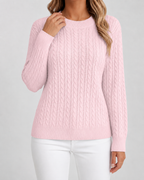 Women’s pink cable knit crew neck sweater with long sleeves and ribbed hem