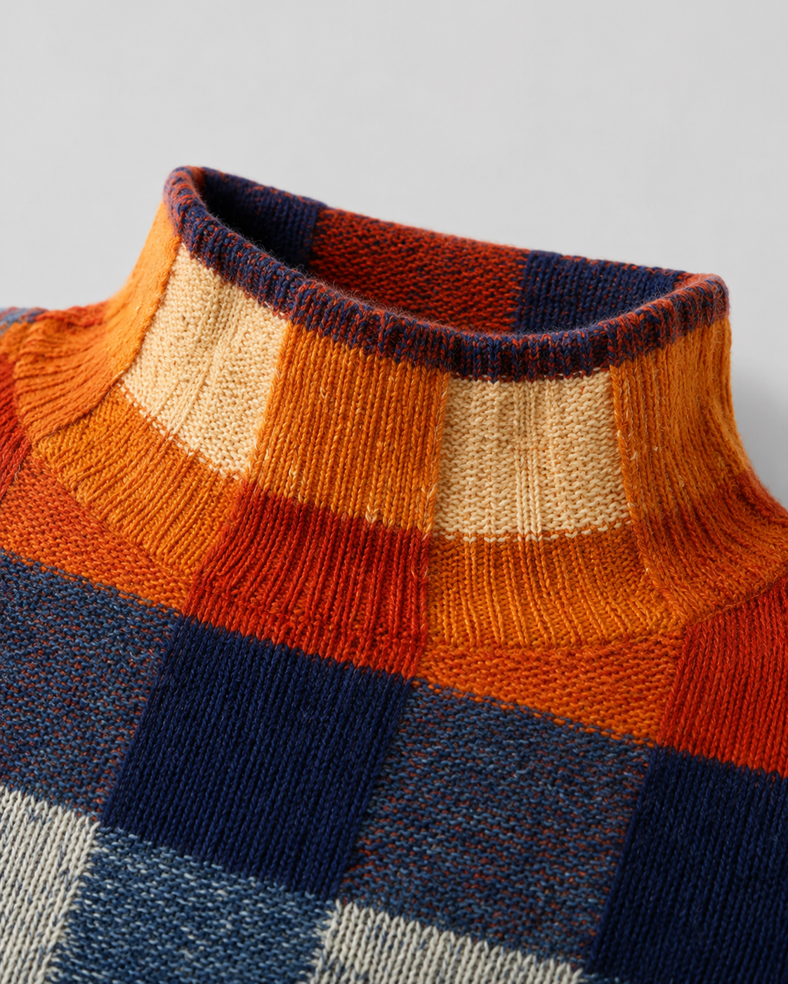 Close-up of multicolor check sweater turtleneck with ribbed collar trim