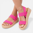Women’s wedge sandals in bright pink with two wide straps and open toe