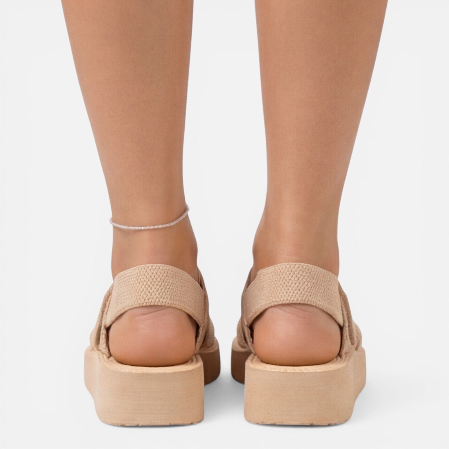 Women’s wedge sandals in beige from back view with ankle bracelet
