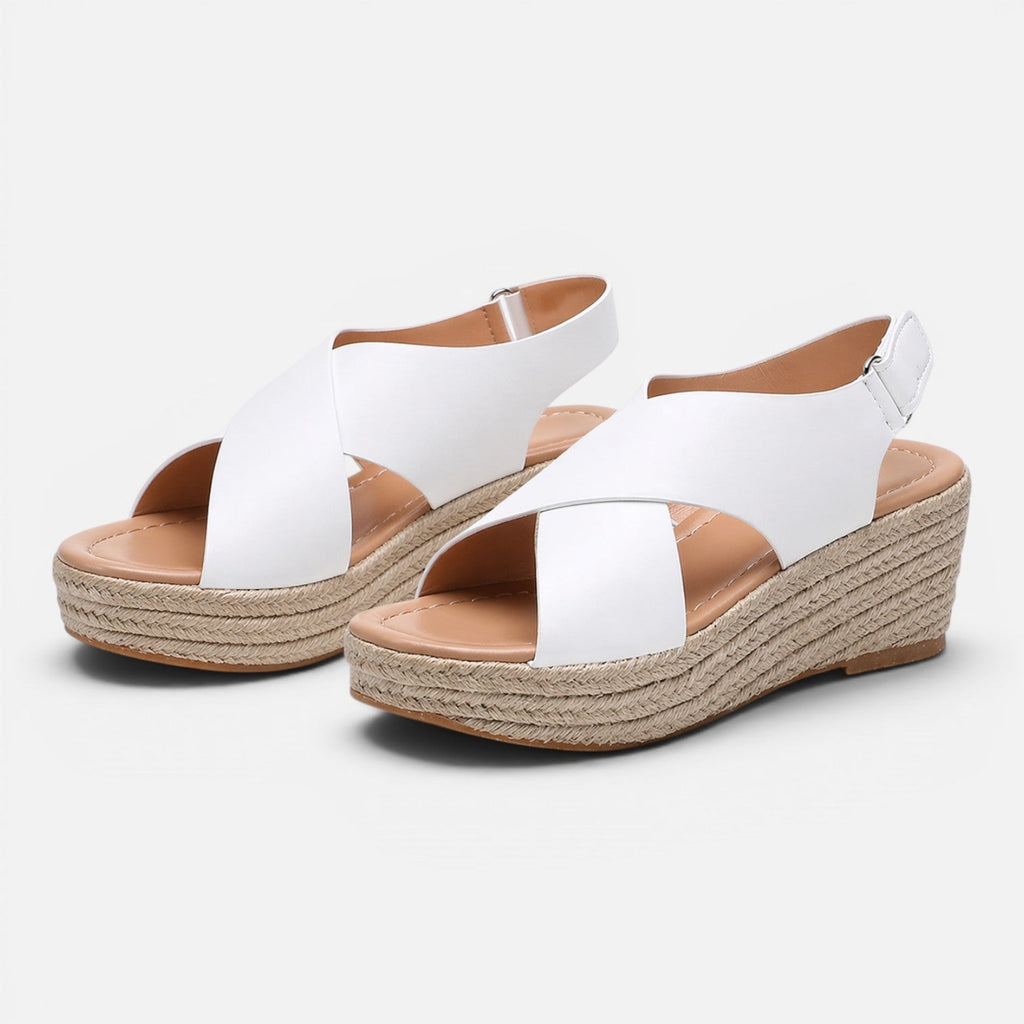 Women’s espadrille wedge sandals in white with crisscross straps and buckle detail