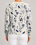 Blue floral knit cardigan with bird motif, button-front, ribbed cuffs and hem.