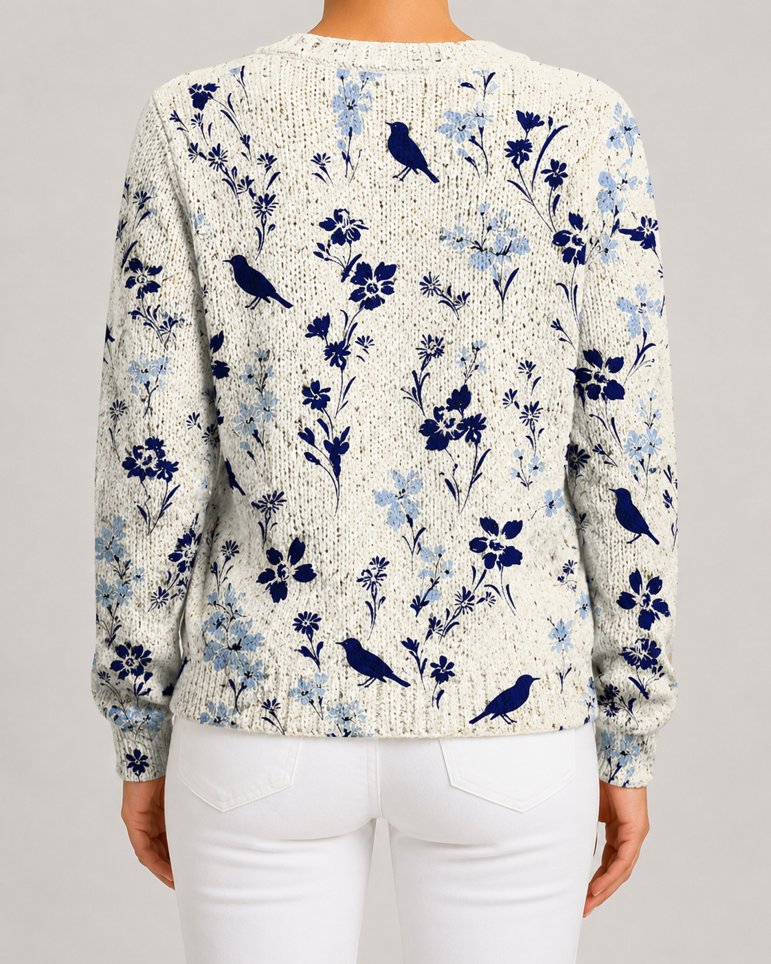 Blue floral knit cardigan with bird motif, button-front, ribbed cuffs and hem.