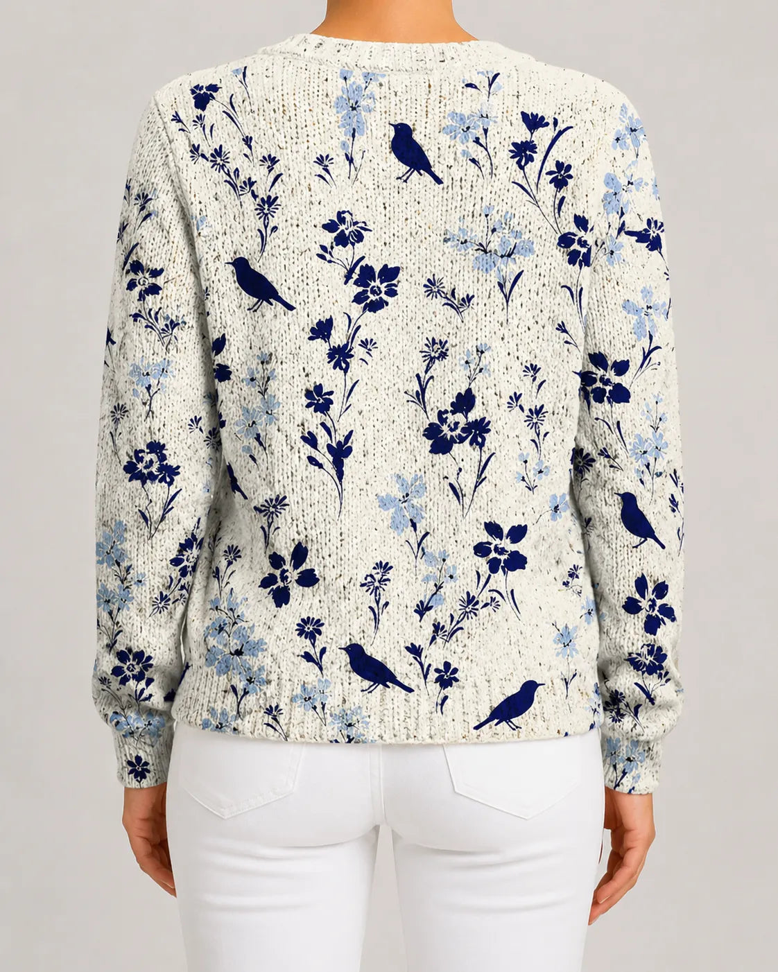 Blue floral knit cardigan with bird motif, button-front, ribbed cuffs and hem.