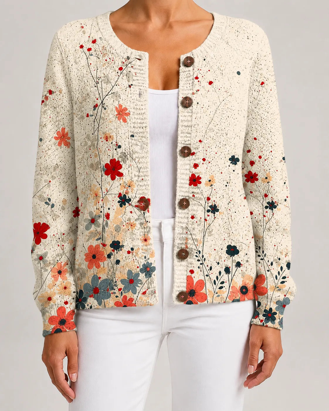 Floral knit cardigan with red and multicolor blossoms, button-front with round dark buttons.