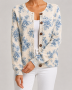 Light blue floral knit cardigan with button-front and ribbed hem, round wooden-look buttons.