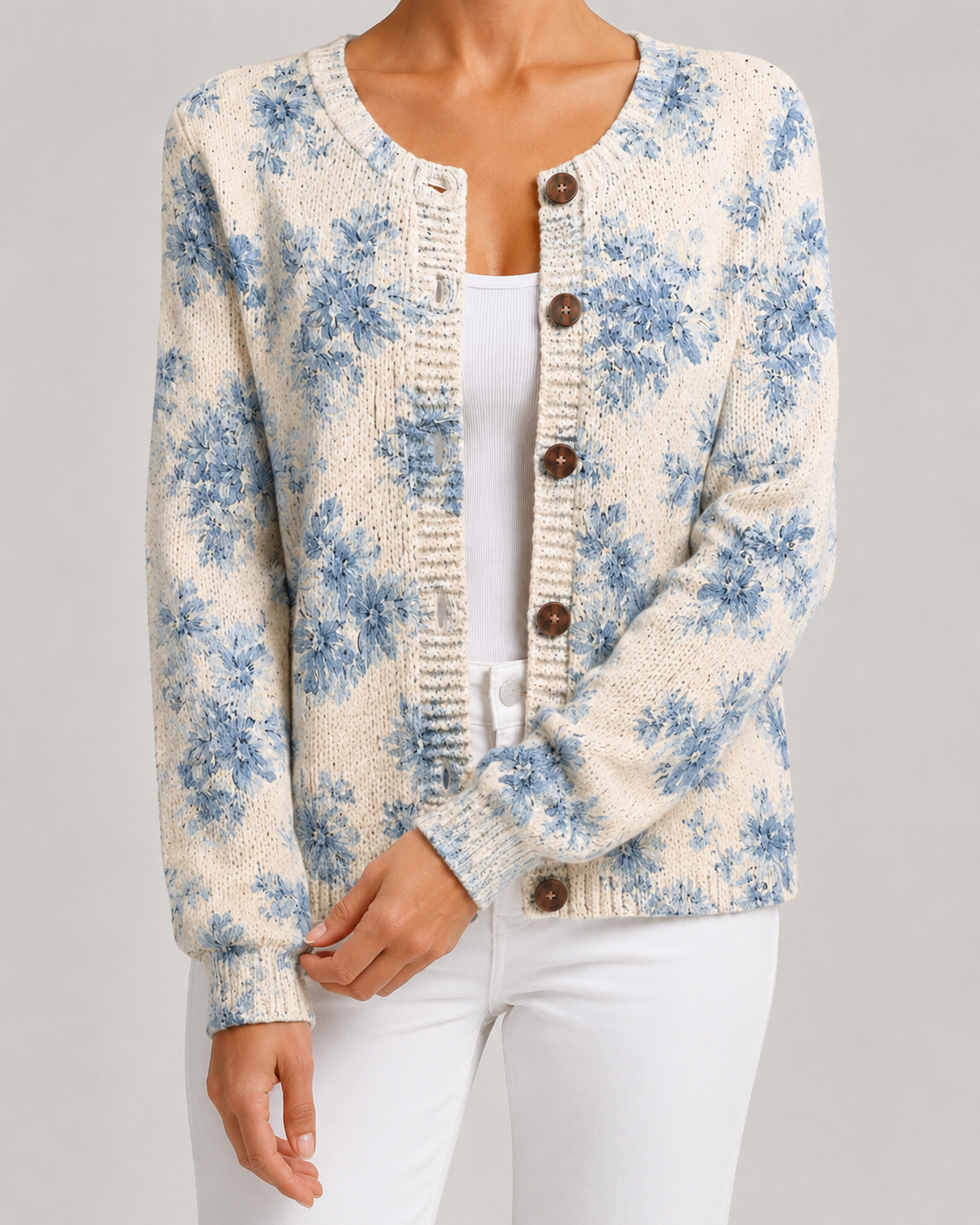 Light blue floral knit cardigan with button-front and ribbed hem, round wooden-look buttons.