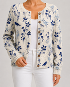 Blue floral knit cardigan with bird motif, button-front with round wooden-look buttons.