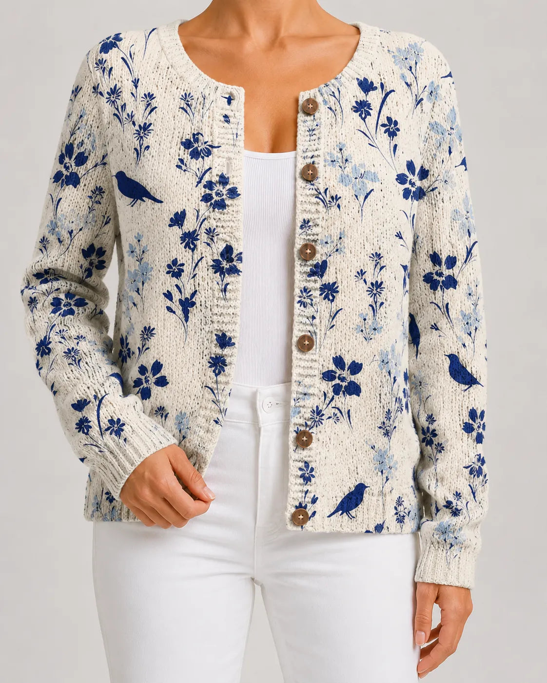 Blue floral knit cardigan with bird motif, button-front with round wooden-look buttons.
