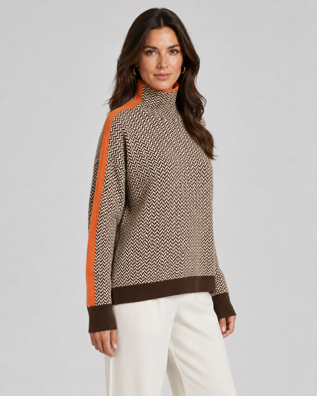 Herringbone knit turtleneck sweater with orange contrast sleeves, beige and dark zigzag