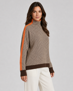 Herringbone knit turtleneck sweater with orange contrast sleeves, beige and dark zigzag