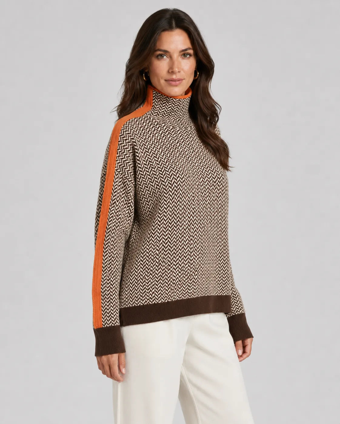 Herringbone knit turtleneck sweater with orange contrast sleeves, beige and dark zigzag