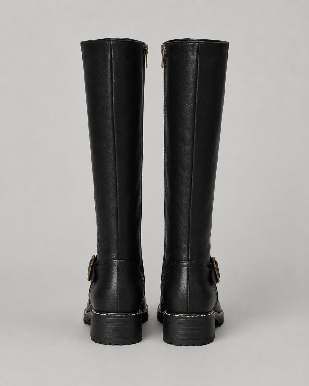 Black knee-high buckle boots with side zip and lug sole, rear pair view.