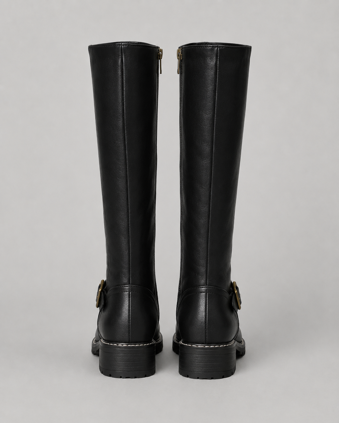 Black knee-high buckle boots with side zip and lug sole, rear pair view.