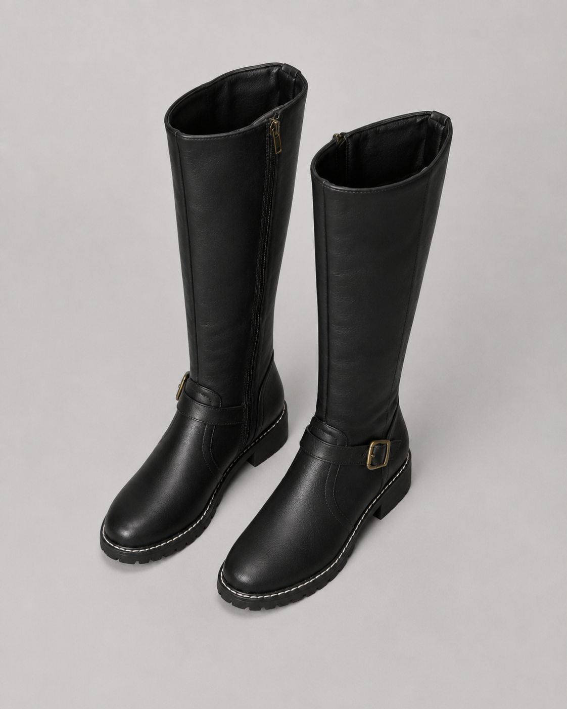 Black knee-high buckle boots with side zip and lug sole, angled side pair view.