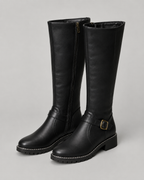 Black knee-high buckle boots with side zip and lug sole, front pair view.