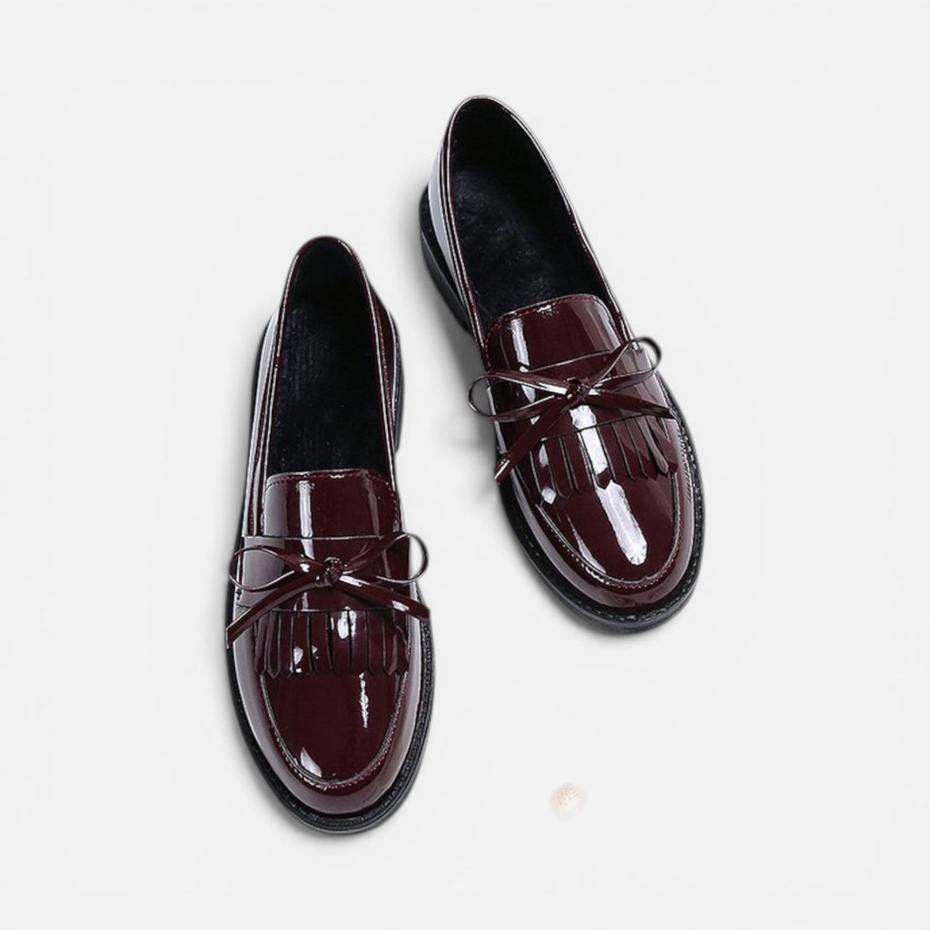 Burgundy patent loafers with tassel detail and slip-on strap, round toe