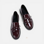 Burgundy patent loafers with tassel detail and slip-on strap, round toe