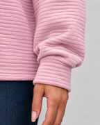 Pink ribbed long sleeve pullover sleeve cuff and half-zip collar detail