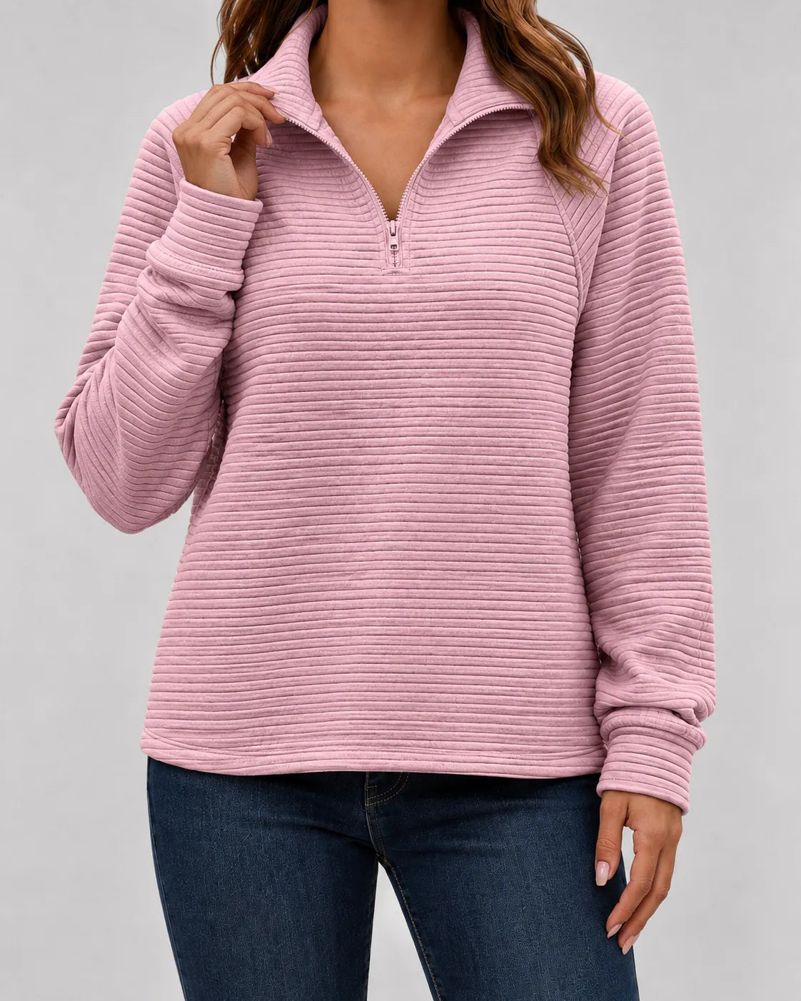 Pink ribbed quarter-zip long sleeve pullover with half-zip closure and collar