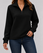 Black ribbed quarter-zip long sleeve pullover with half-zip front and long cuffs