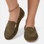 Women’s slip-on loafers in dark green suede with gold-tone metal buckle and tassel trim