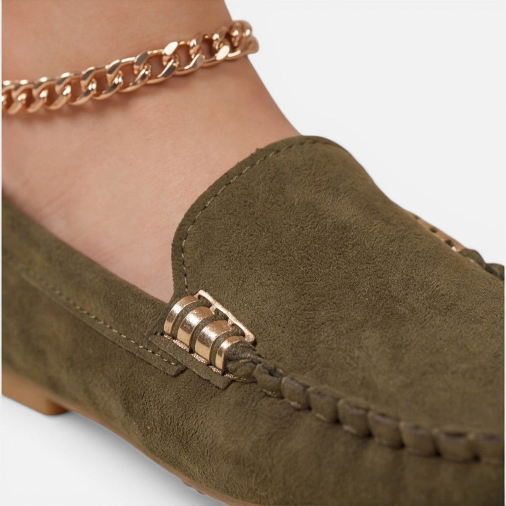 Women’s slip-on loafers in dark green suede with gold-tone metal buckle close-up