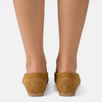 Women’s slip-on loafers in tan suede, back view with stitched heel and flat sole