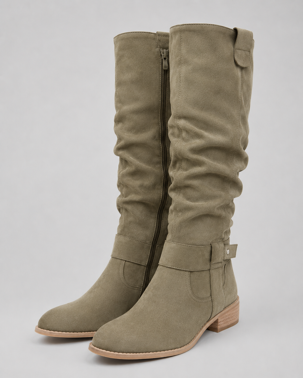 Green suede knee-high boots with low heel and side zip closure