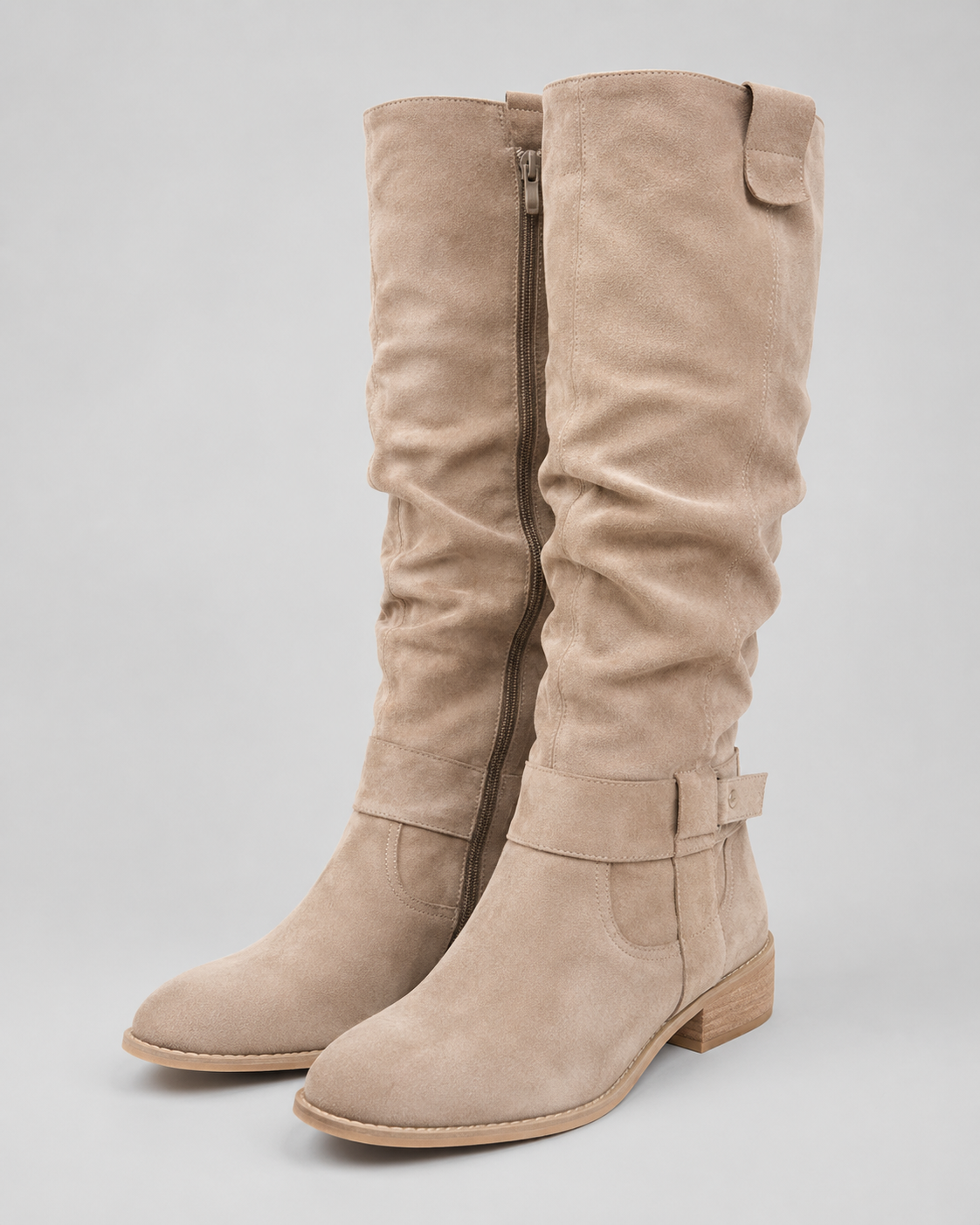 Beige suede knee-high boots with low heel and side zip closure