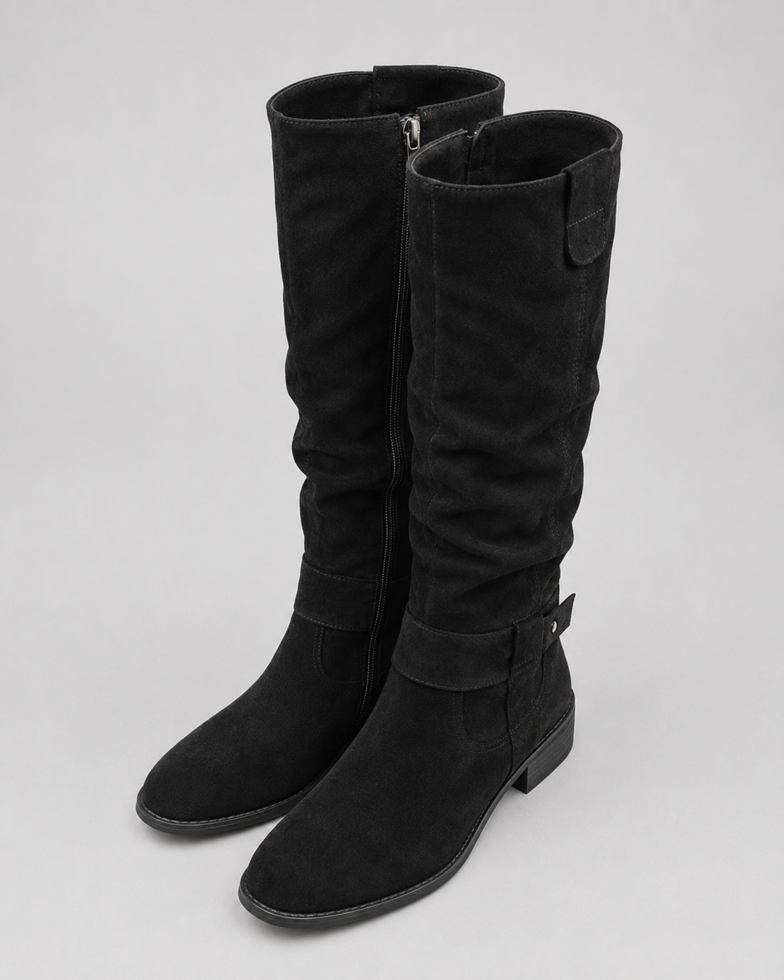 Black suede knee-high boots with side zip, low heel, and ankle strap detail