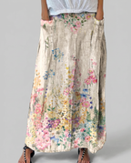 Women's A-line maxi skirt back view, light gray fabric with multicolor vintage florals