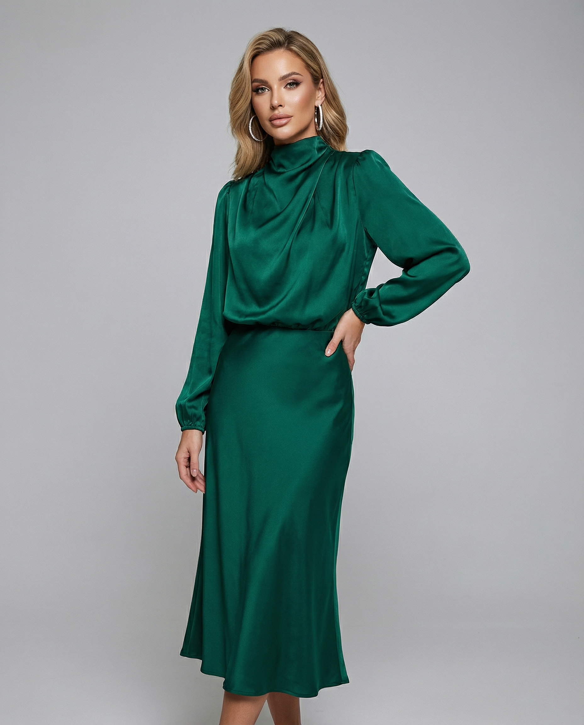 Emerald green satin midi dress with long sleeves, high neckline, and gathered waist