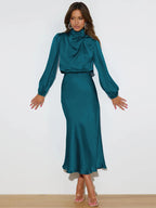 Teal satin midi dress with long sleeves, high neck, and flared skirt
