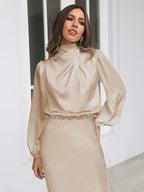 Beige satin midi dress with long puff sleeves, high neck, and cinched waist