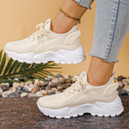 Women's sneakers in off-white knit with lace-up, cushioned chunky sole, mesh panels.