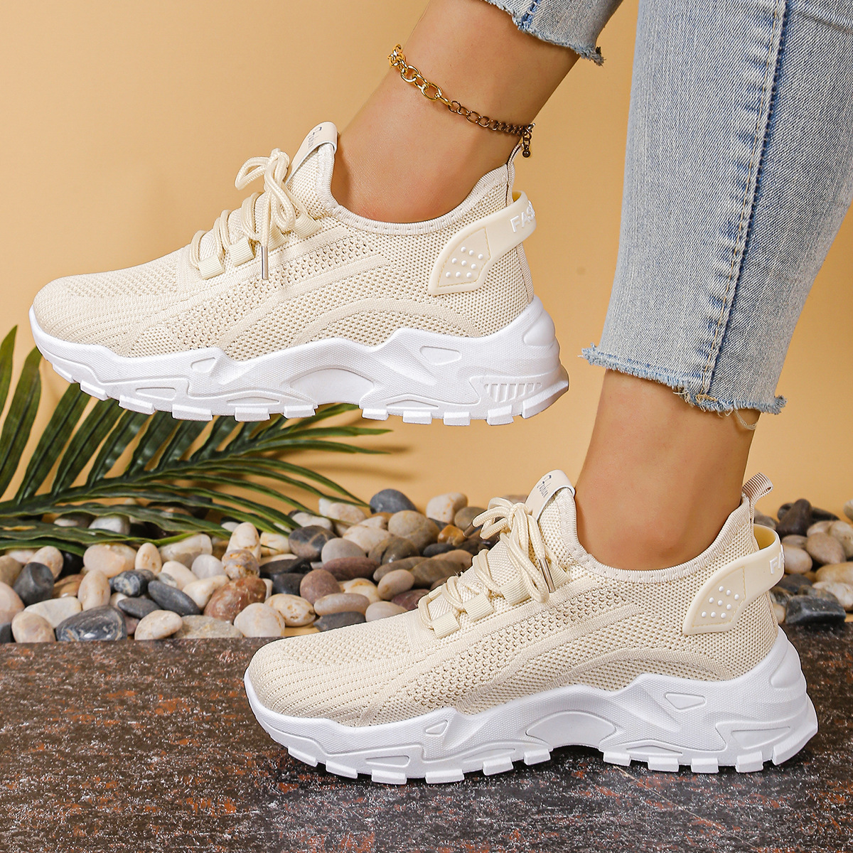 Women's sneakers in off-white knit with lace-up, cushioned chunky sole, mesh panels.