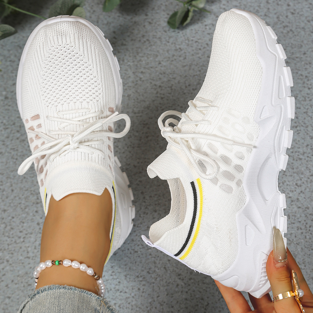 Women's sneakers in off-white mesh with lace-up, chunky white sole, yellow accent stripe.