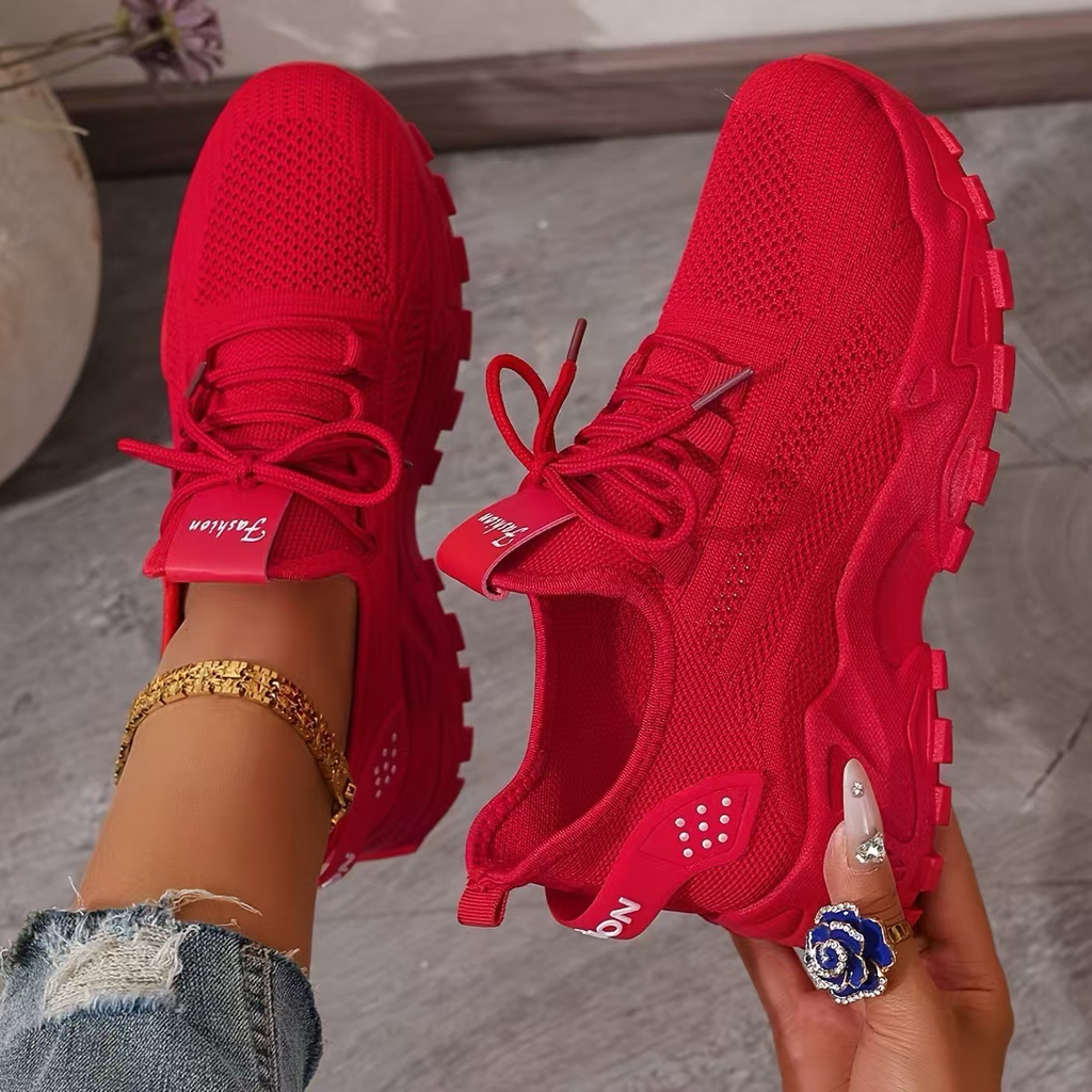 Women's sneakers in red knit with lace-up, padded collar, chunky white tread sole.