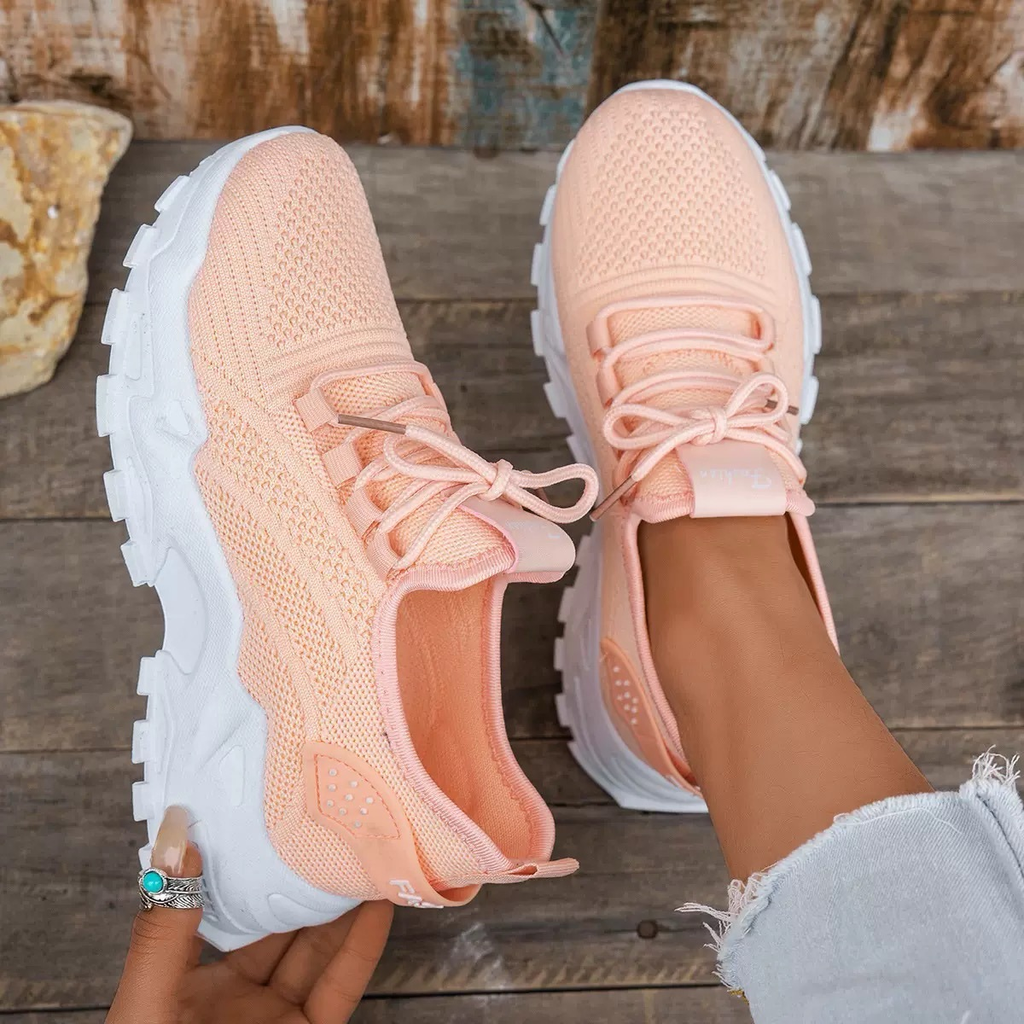 Women's sneakers in light peach knit with lace-up, breathable texture, white tread sole.