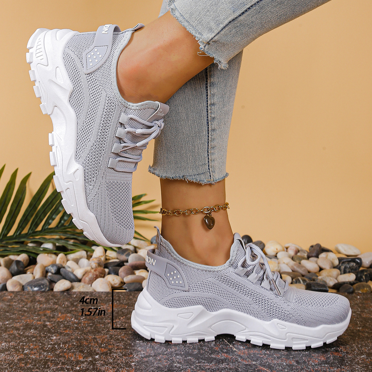 Women's sneakers in light gray mesh with lace-up, cushioned chunky white tread sole.