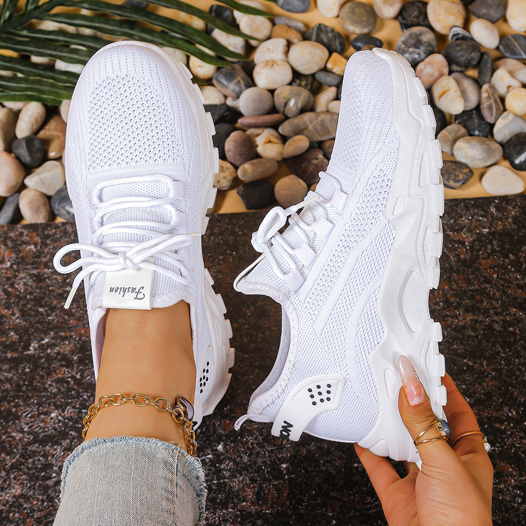 Women's sneakers in white mesh with lace-up, padded collar, chunky white tread sole.