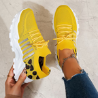 Women's sneakers in bright yellow knit with lace-up, leopard-print side, white tread sole.