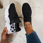 Women's sneakers in black knit with lace-up, white speckled side panel, chunky white sole.