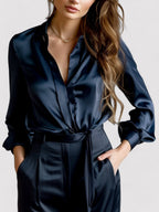 Navy satin long-sleeve blouse with button front, pointed collar, and waist tie