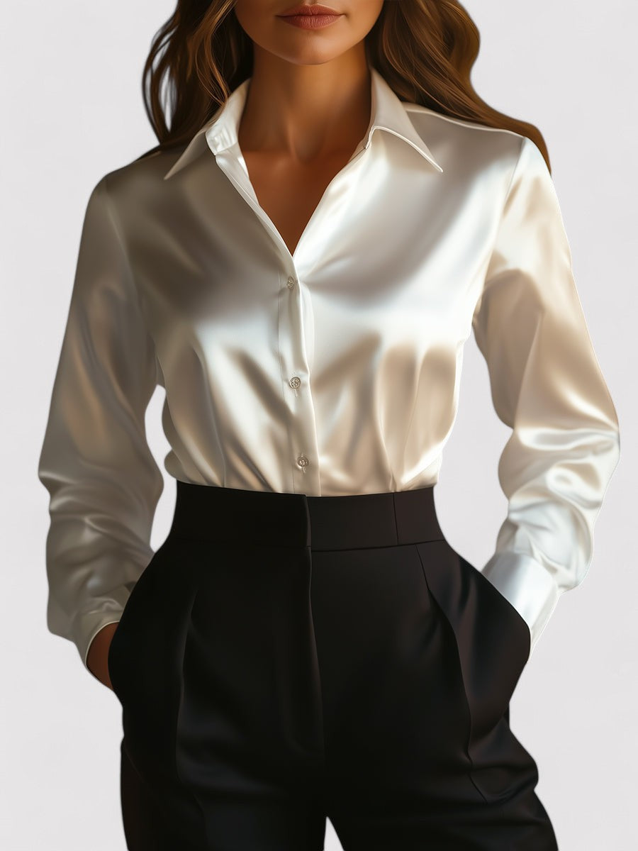 White satin long-sleeve blouse with button front and pointed collar, worn with black pants