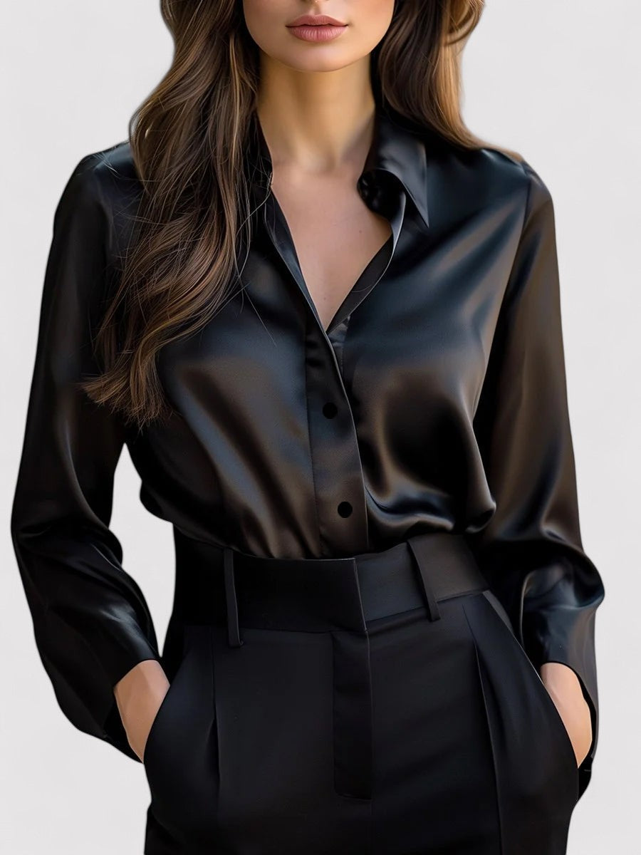 Black satin long-sleeve blouse with button front, pointed collar, and tied waist belt