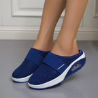 Blue backless slip-on knit sneakers with white rubber sole and oval detail